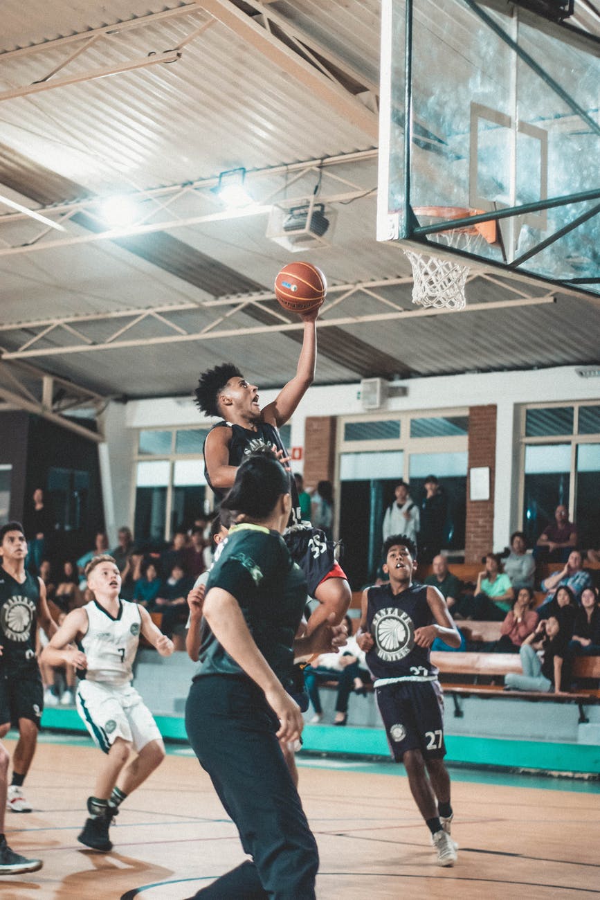 photo of men playing basketball